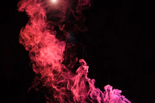 pink spiritual smoky swirl with light on black background - Photo, Image