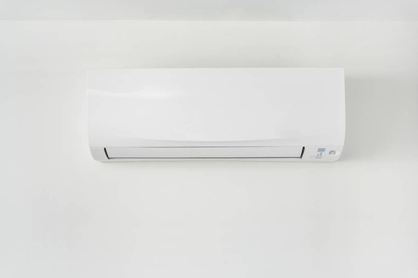 Air conditioner on white concrete wall in area of room space. - Foto, imagen