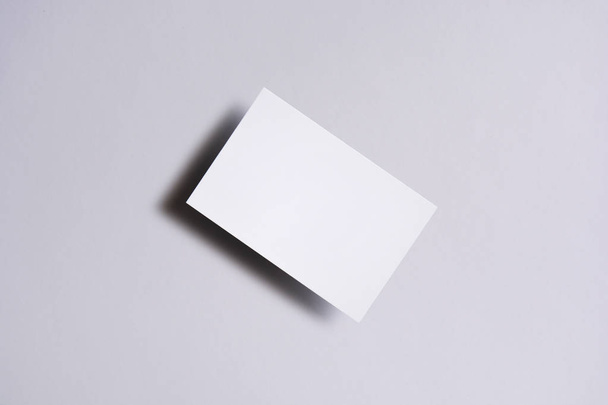 Photo of blank business cards on white. Mock-up for branding identity. For graphic designers presentations and portfolios - Φωτογραφία, εικόνα