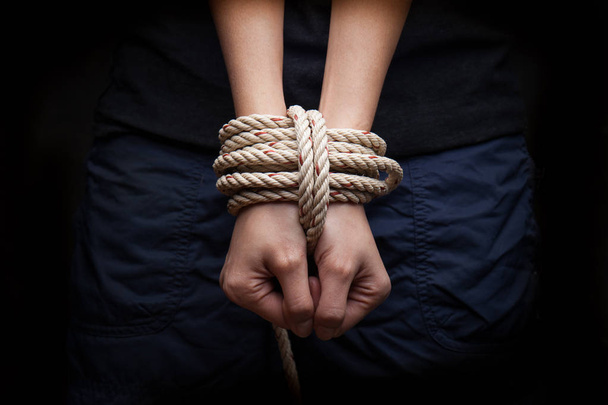Hands of a victim woman tied up with rope  - Foto, Imagem