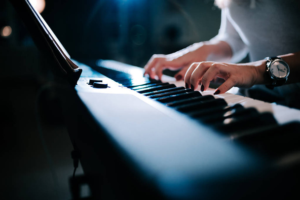 Close-up view of a female hands playing piano synhtesizer. - Valokuva, kuva
