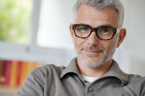 Portrait of smiling middle-aged man with eyeglasses - Foto, afbeelding