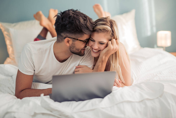 Young couple enjoying in their bedroom. - Fotografie, Obrázek