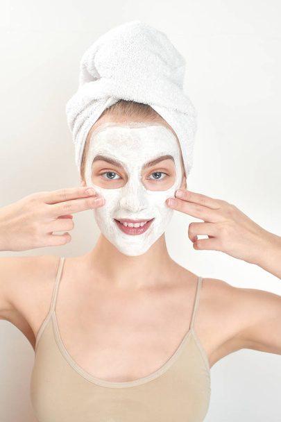 beautiful woman with towel on head and mask on face, skin care concept  - Фото, зображення