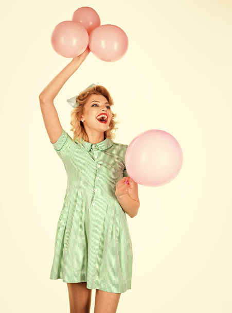 Celebration. Ballons. pinup girl holding pink balloons - Fotó, kép