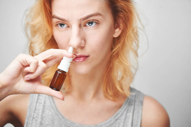sick woman with spray dripping nose drops, allergy concept - Fotoğraf, Görsel