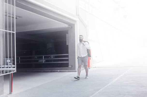 Business man walking on walk way in car park of airport parking lot. natural light effect - Φωτογραφία, εικόνα