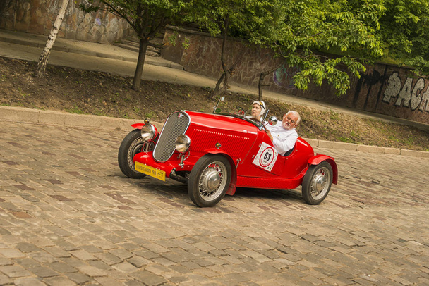 Lviv, Ukraine - June 3, 2018:Old retro car Fiat 508 Sport with its owner and an unknown passenger taking participation in race Leopolis grand prix 2018, Ukraine. - Photo, image