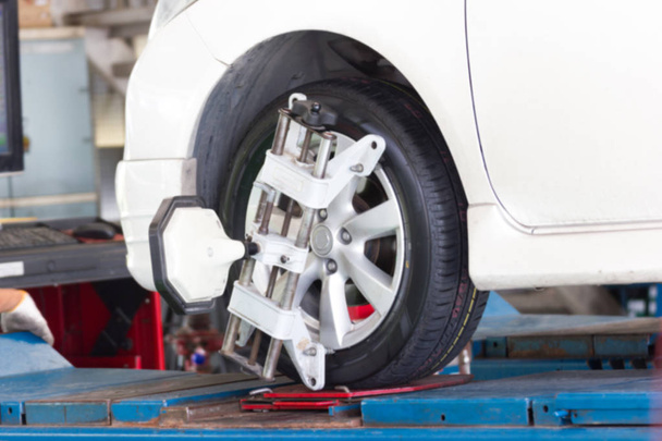Blurred - At the car service center, the white car is entering service. Car wheel alignment  - Photo, image