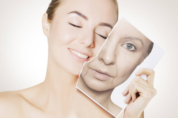 closeup portrait of young woman face holding portrait with old wrinkled face - Foto, Bild