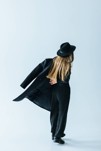 Young caucasian woman with black coat - Foto, afbeelding