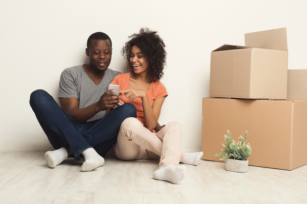 Black couple sitting on floor at new apartment - Photo, Image