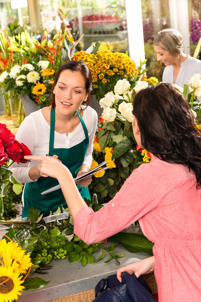 Young florist ordering roses woman customer flower - Φωτογραφία, εικόνα