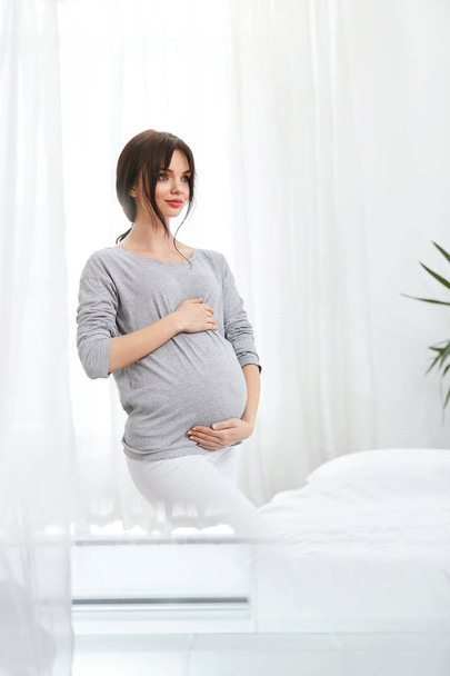 Pregnant Girl. Beautiful Smiling Pregnant Woman With Baby Belly At Home. High Resolution - Photo, Image