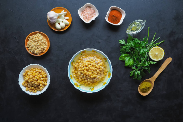 Ingredients for hummus on the black kitchen table. Top view. - Fotografie, Obrázek