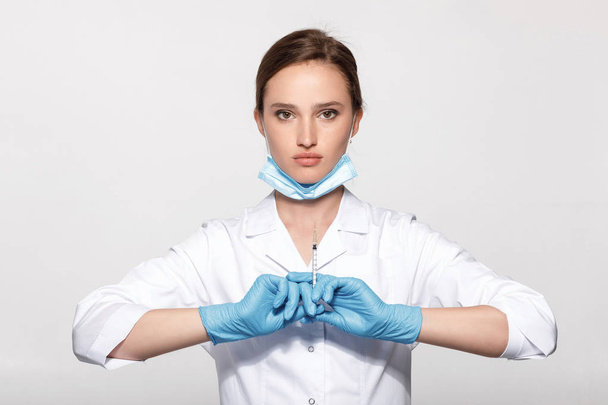 doctor in uniform and gloves with syringe - Photo, Image