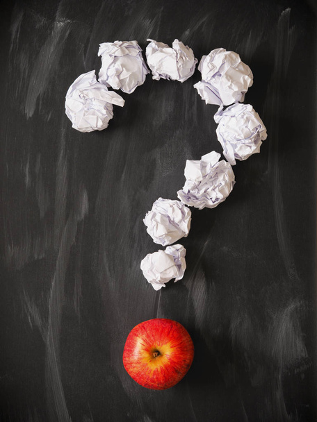 Question mark of crumpled paper with a red apple on a blackboard - Fotografie, Obrázek