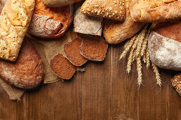 Bakery. Bread On Wood Background. Closeup Of Variety Of Baked Food On Wooden Table. High Resolution - Фото, изображение