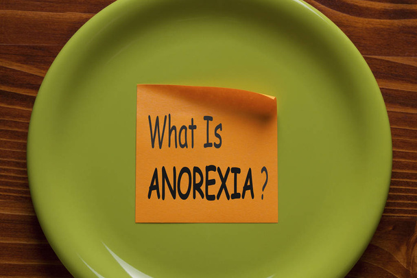 ¿Qué está escrito ANOREXIA en nota adhesiva en el plato verde. Concepto médico
. - Foto, Imagen