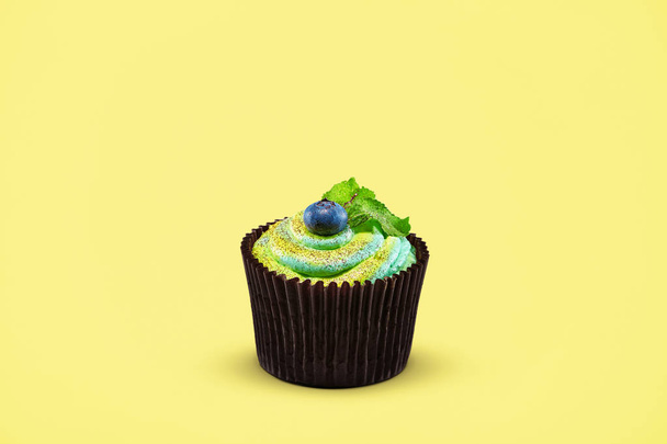 Cupcake. Cake Dessert With Blueberry On Colorful Yellow Background. Close Up Of Tasty Pastry. High Resolution - Foto, Imagen