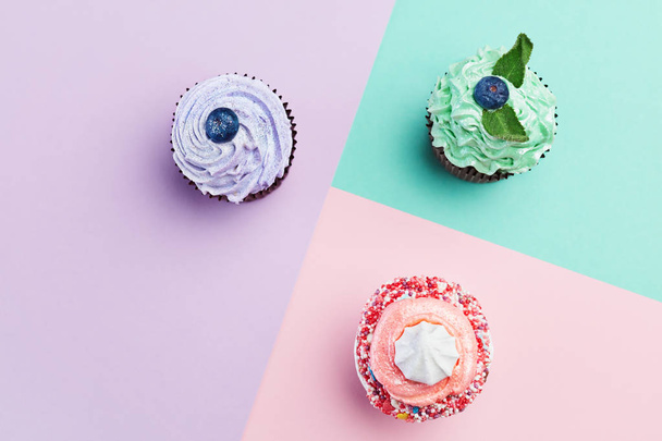Dessert. Cupcakes On Colorful Background. Close Up Of Mini Cakes With Pastel Color Cream. High Resolution - Foto, imagen