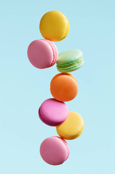 Macaron Biscuit. Colorful Macaroons Flying. French Dessert In Motion Falling On Blue Background. High Resolution - Photo, image