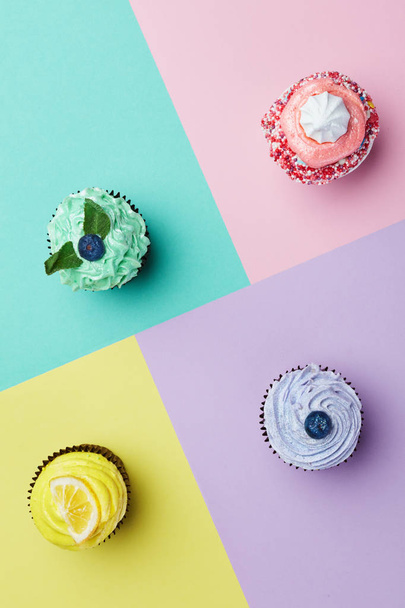 Cupcakes Desserts On Colorful Background. Cakes With Different Colors Cream And Toppings. High Resolution - Foto, afbeelding