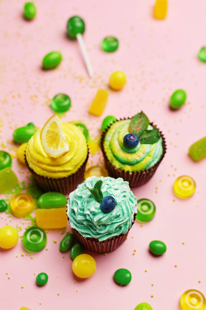 Cupcakes And Candies. Sweets And Desserts On Pink Background. High Resolution - Фото, зображення