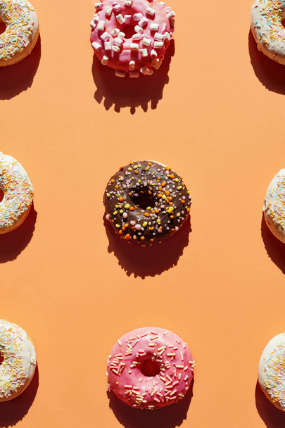 Donuts On Colorful Background. Close Up Of Sweet Food, Doughnuts With Sprinkles And Glaze. High Resolution - Fotó, kép