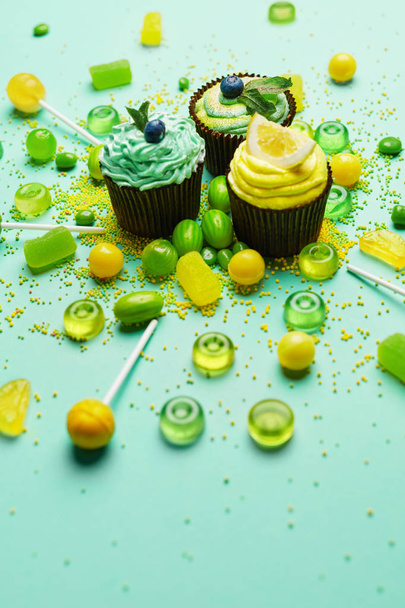 Cupcakes And Candies. Sweets And Desserts On Green Background. High Resolution - Photo, image