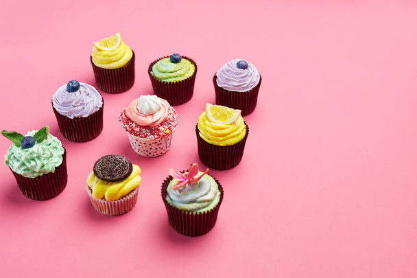 Colorful Cupcakes On Pink Background. Cake Desserts With Cream And Different Toppings. High Resolution - Foto, afbeelding