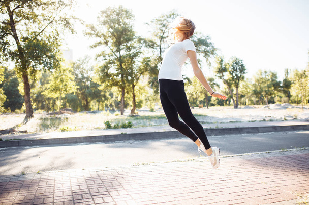 young athletic girl doing exercise, posing in a jump, can be used for advertising - Φωτογραφία, εικόνα