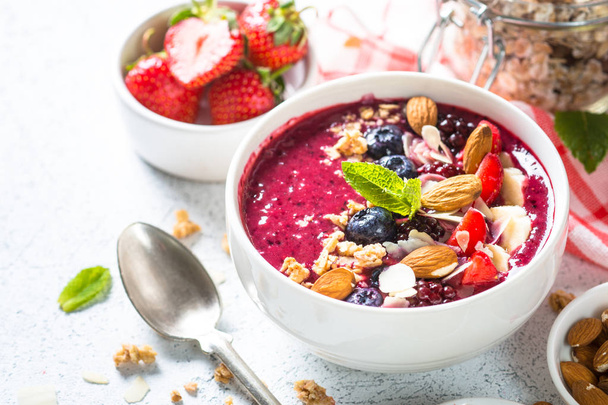 Smoothie bowl from fresh berries, nuts and granola. - Photo, Image