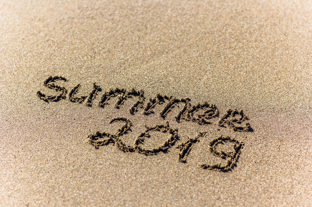 The word summer written in the sand on a beach - Foto, Imagen