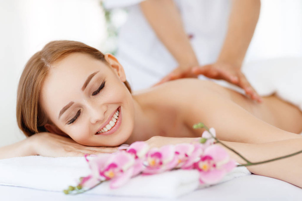 a beautiful girl enjoys massage and spa treatment - Photo, Image