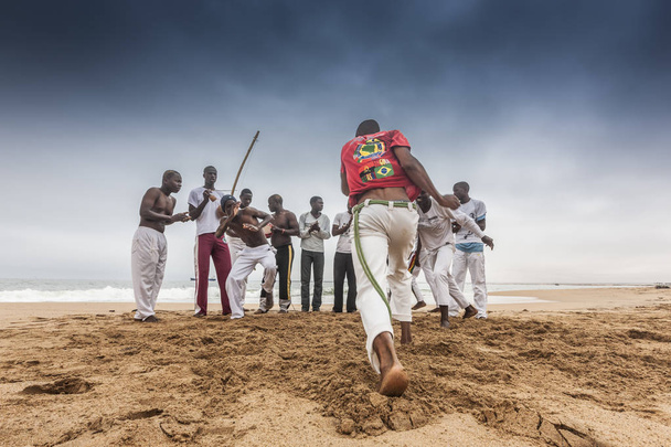 NAMIBE/ANGOLA - 28 AUG 2013 - African sportsmen practicing the famous Brazilian capoeira fight - Photo, Image