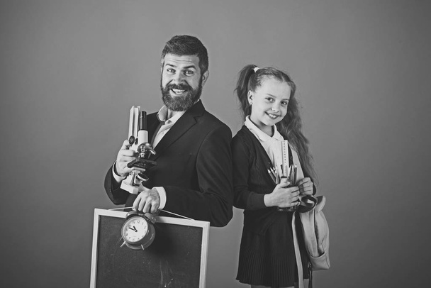 School time. Man with beard and girl in uniform. Teacher and schoolgirl - Photo, Image