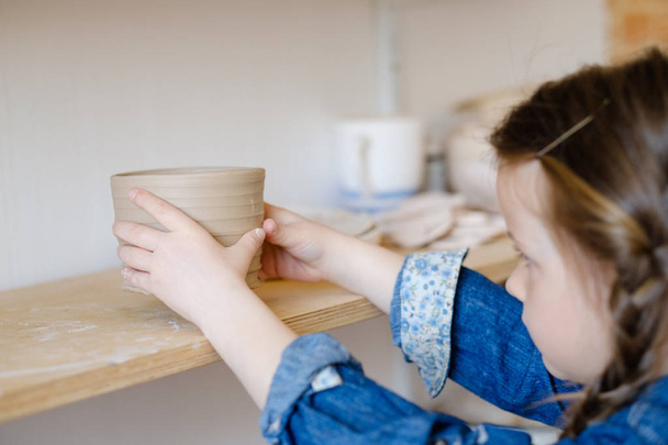child hobby creative pottery put clay jug shelf - Foto, Imagem