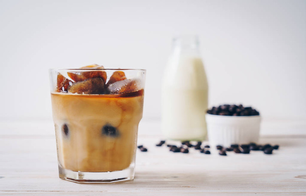 coffee ice cubes with milk on wood table - Foto, Imagen