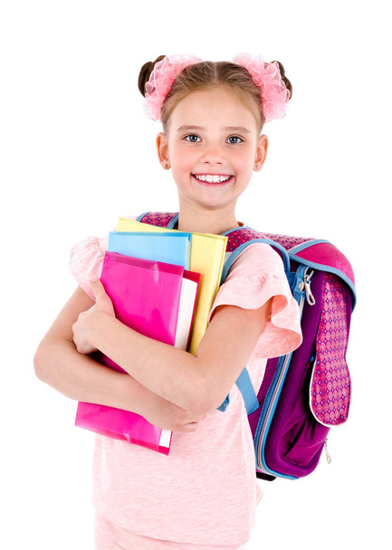 Portrait of smiling happy school girl child with school bag backpack and books isolated on a white background education concept - Fotó, kép