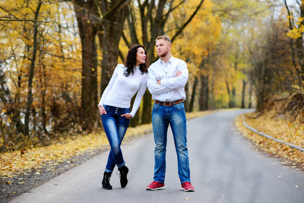 Les amoureux marchent main dans la main dans le parc d'automne - Photo, image
