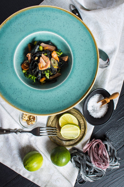 Cuttlefish Ink Black Pasta with Salmon and Vegetables - Photo, Image
