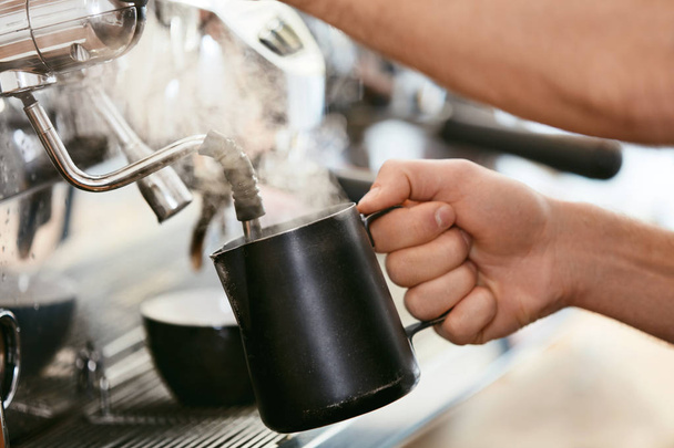 Barista Preparing Coffee On Coffee Machine Closeup, Steaming Milk In Cup In Cafe. High Resolution. - 写真・画像