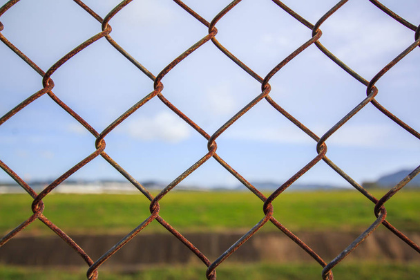 Chain link fence with grass field Phuket International Airport - Photo, Image