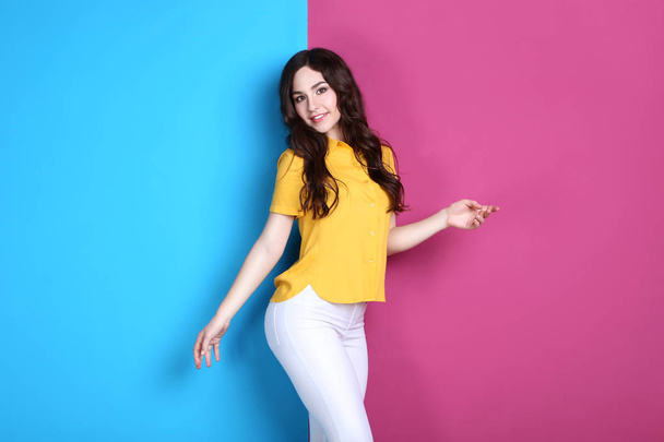 Portrait of beautiful woman on colorful background - Photo, Image