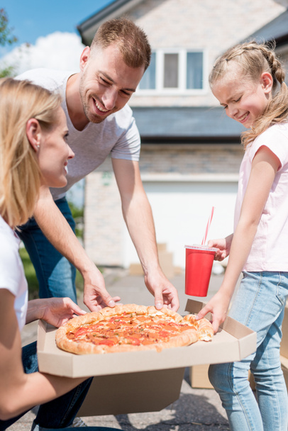 happy family with daughter preparing to eat pizza  - Foto, Imagem