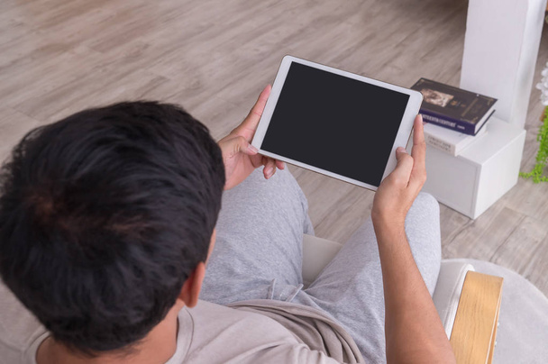 man using empty tablet for tablet application mock up - Fotó, kép