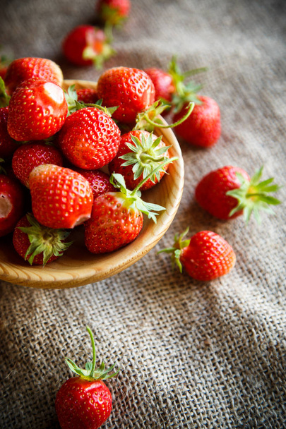 ripe red strawberry on a table with burlap - 写真・画像