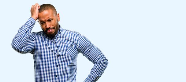 African american man with beard doubt expression, confuse and wonder concept, uncertain future isolated over blue background - Foto, immagini