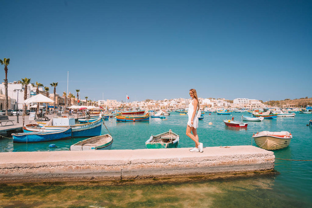 May 20, 2018. Marsaxlokk, Malta. Beautiful view on the traditional eyed colorful boats Luzzu in the Harbor of Mediterranean fishing village Marsaxlokk, Malta  - Foto, afbeelding
